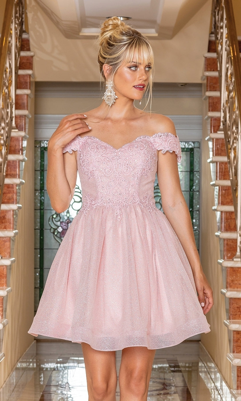 A woman stands indoors on a tiled floor between two staircases, wearing the Off-the-Shoulder Short Pastel Hoco Dress 3292 and dangling earrings.